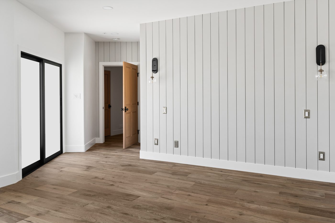 Shiplap hallway wall with black sliding door, Scottsdale whole-home remodel