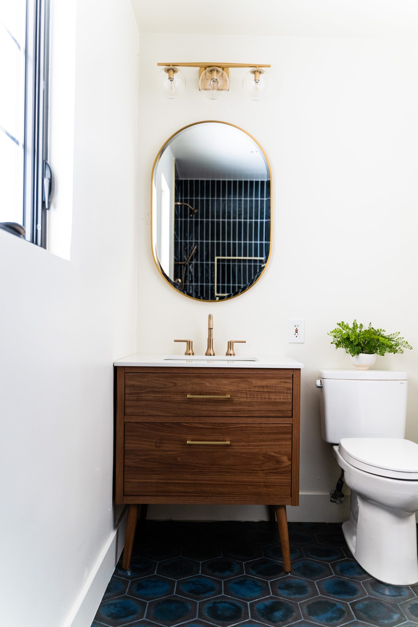 Powder room with wood vanity and blue tile floor, Arcadia whole-home remodel