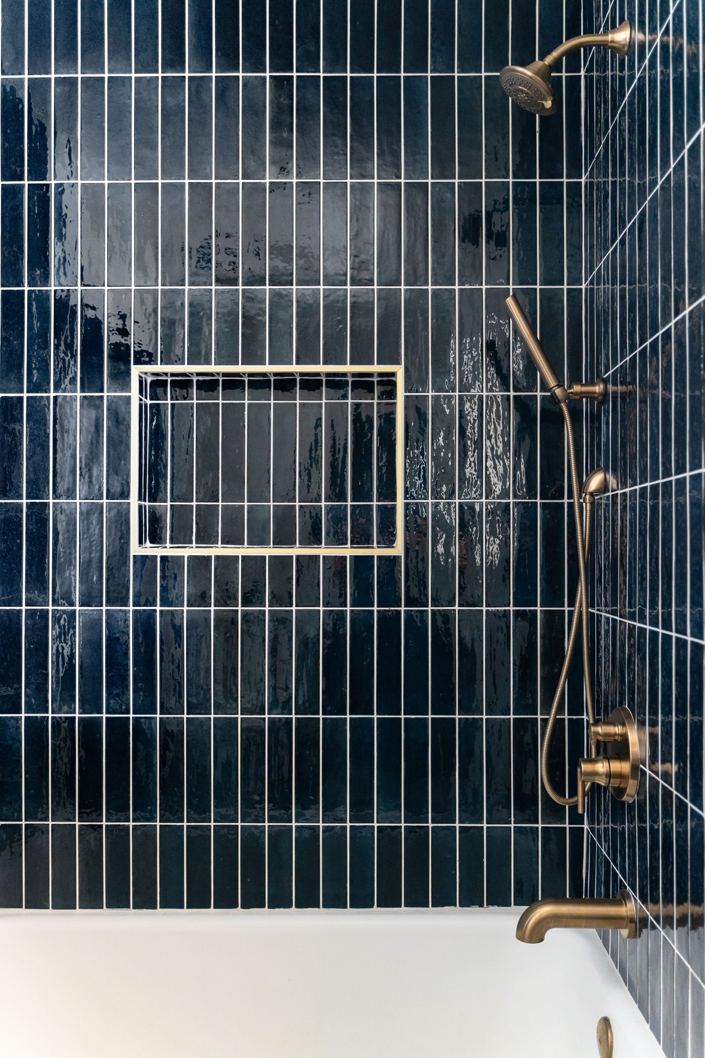 Blue tiled shower detail with brass fixtures, Arcadia whole-home remodel
