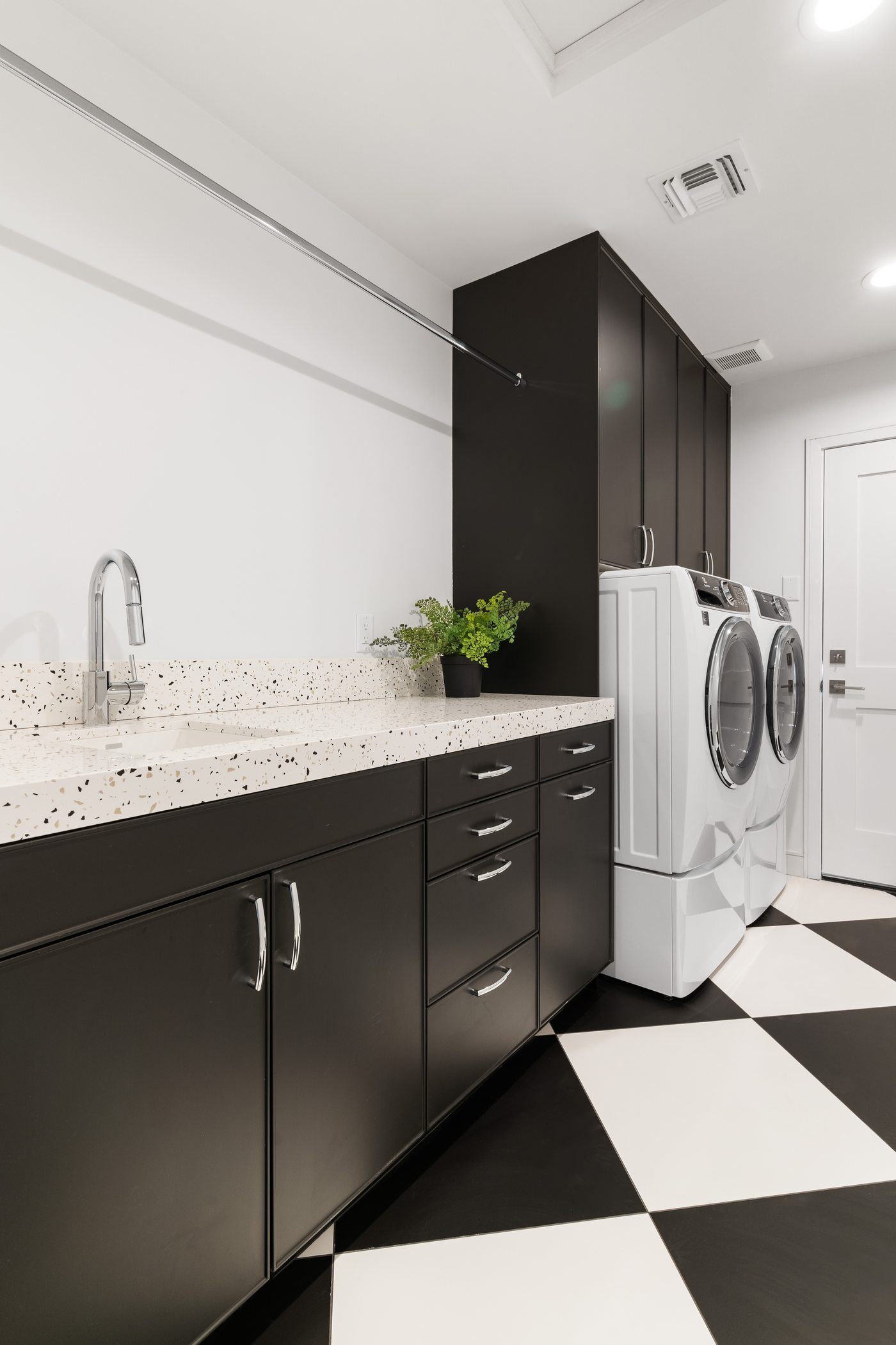 Laundry room with checkerboard floor and dark cabinetry, Paradise Valley custom home