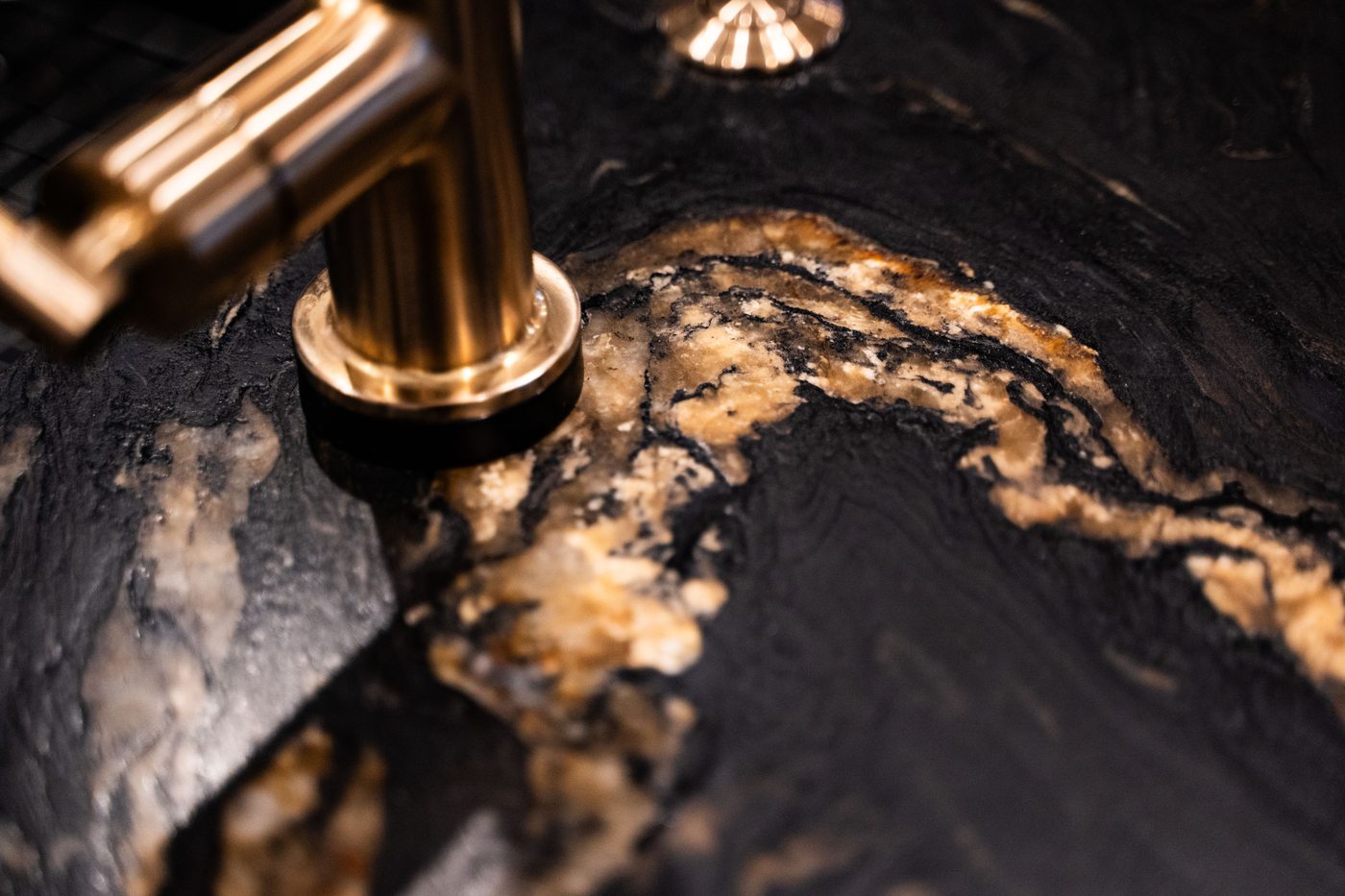 Gold faucet on black and gold marble, Paradise Valley partial remodel