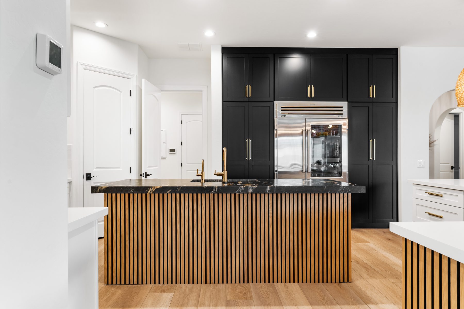 Kitchen with black cabinetry and wood slat island, Paradise Valley partial remodel