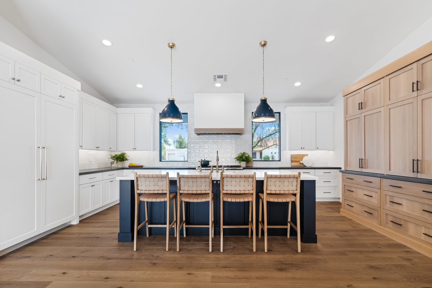 Kitchen with black island and woven bar stools, Scottsdale whole-home remodel