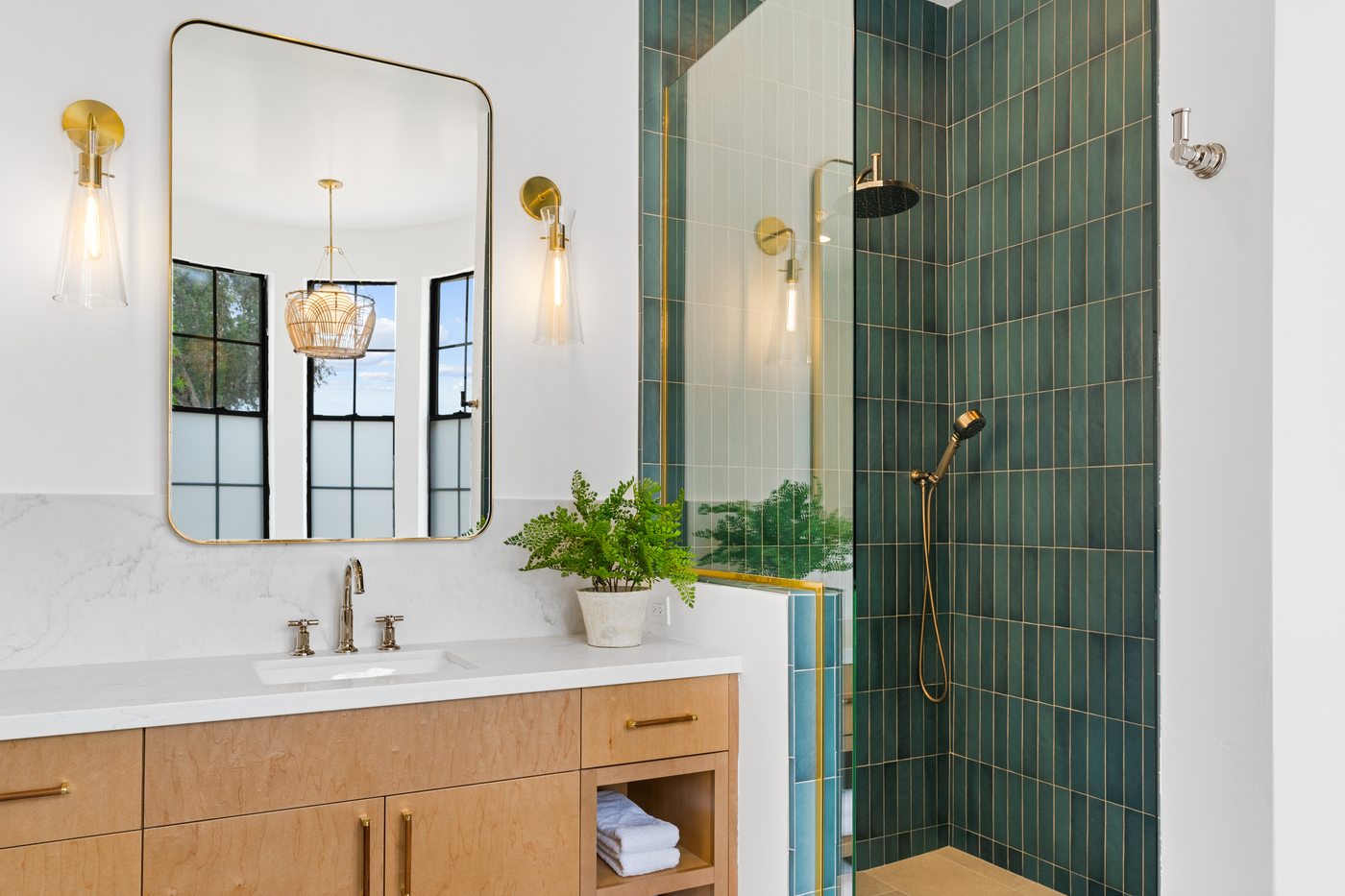 Primary bathroom with green tile and brass fixtures, Scottsdale whole-home remodel