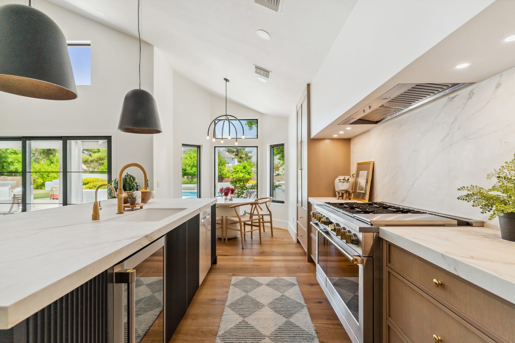 Kitchen with black island and marble backsplash, Gilbert whole-home remodel