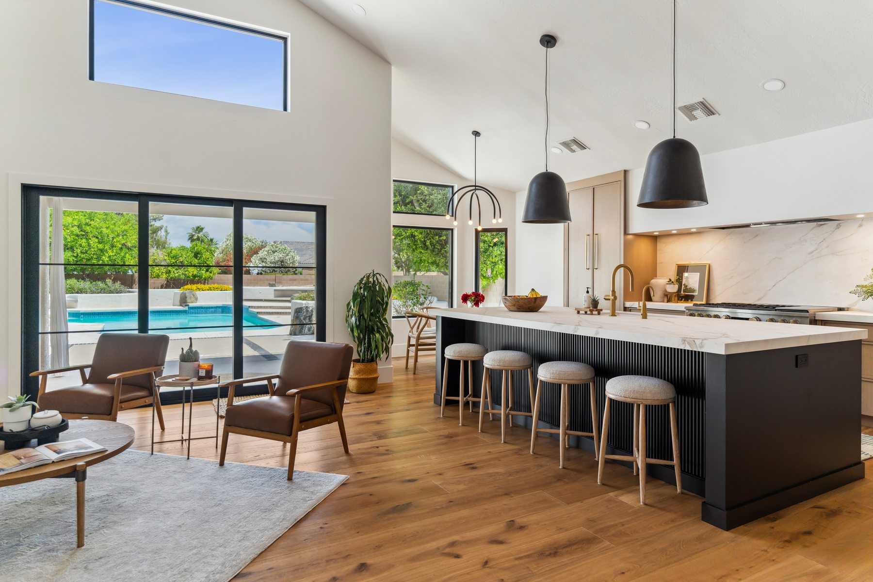 Living and kitchen area with pool visible through sliding doors, Gilbert whole-home remodel