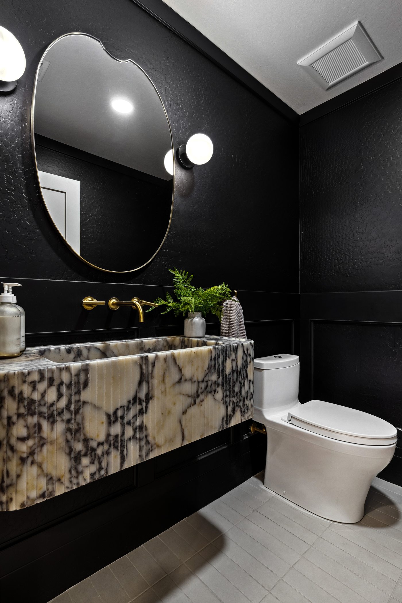 Dramatic black powder room with marble vanity, Gilbert whole-home remodel
