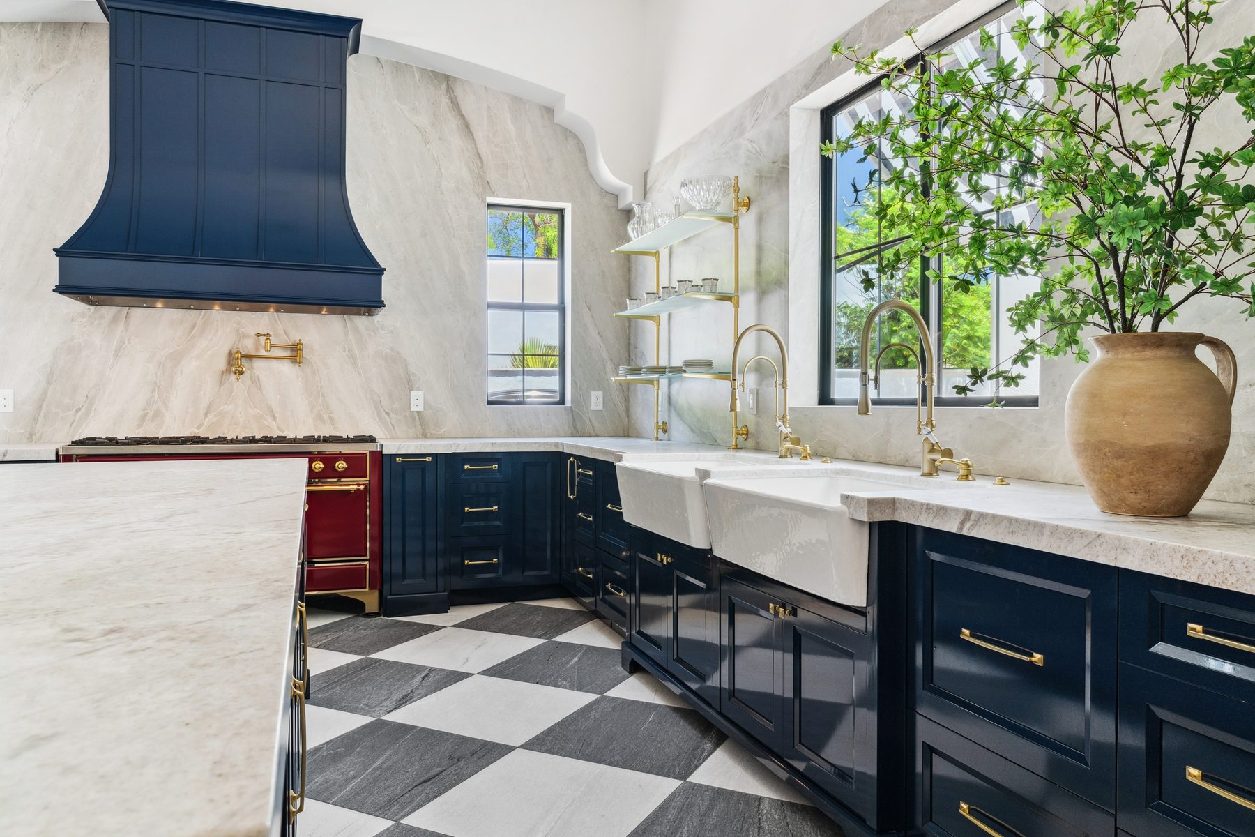 Navy blue kitchen with brass fixtures and checkerboard floor, Scottsdale whole-home remodel