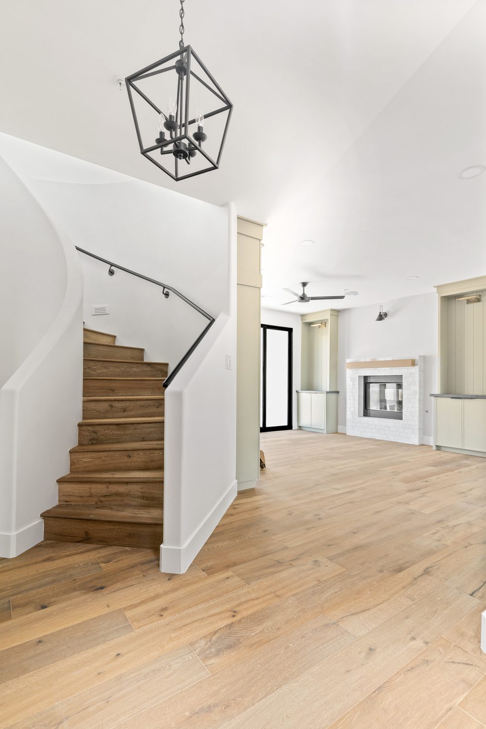 Staircase landing with wood treads and pendant chandelier, Manning residence, Scottsdale