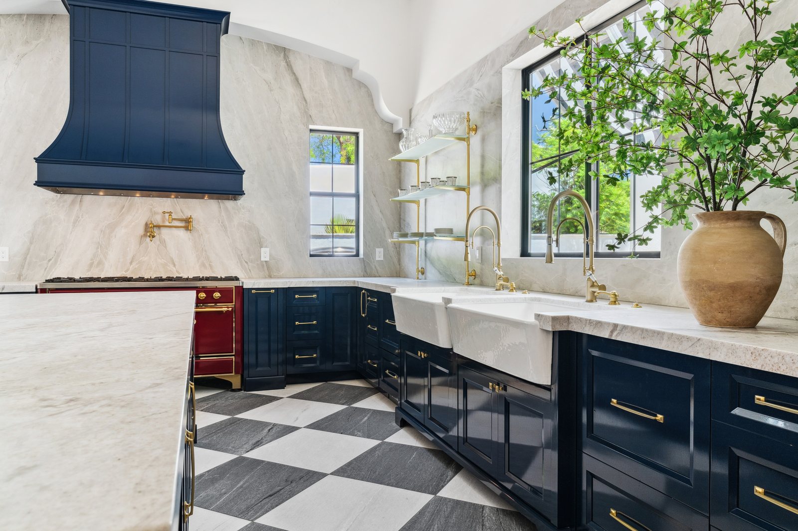 Navy blue custom kitchen with brass fixtures and checkerboard tile floor, Trinity Remodeling project